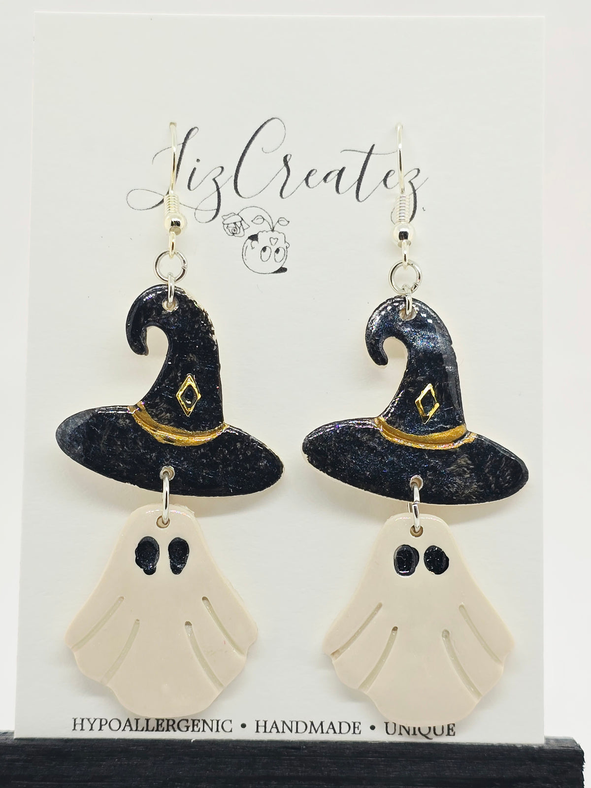 Handmade ghost witch hat earrings sculpted from polymer clay and coated in glossy, non-toxic resin, measuring approximately 2.25 inches from top to bottom. Unique Halloween-inspired gothic jewelry by LizCreatez.