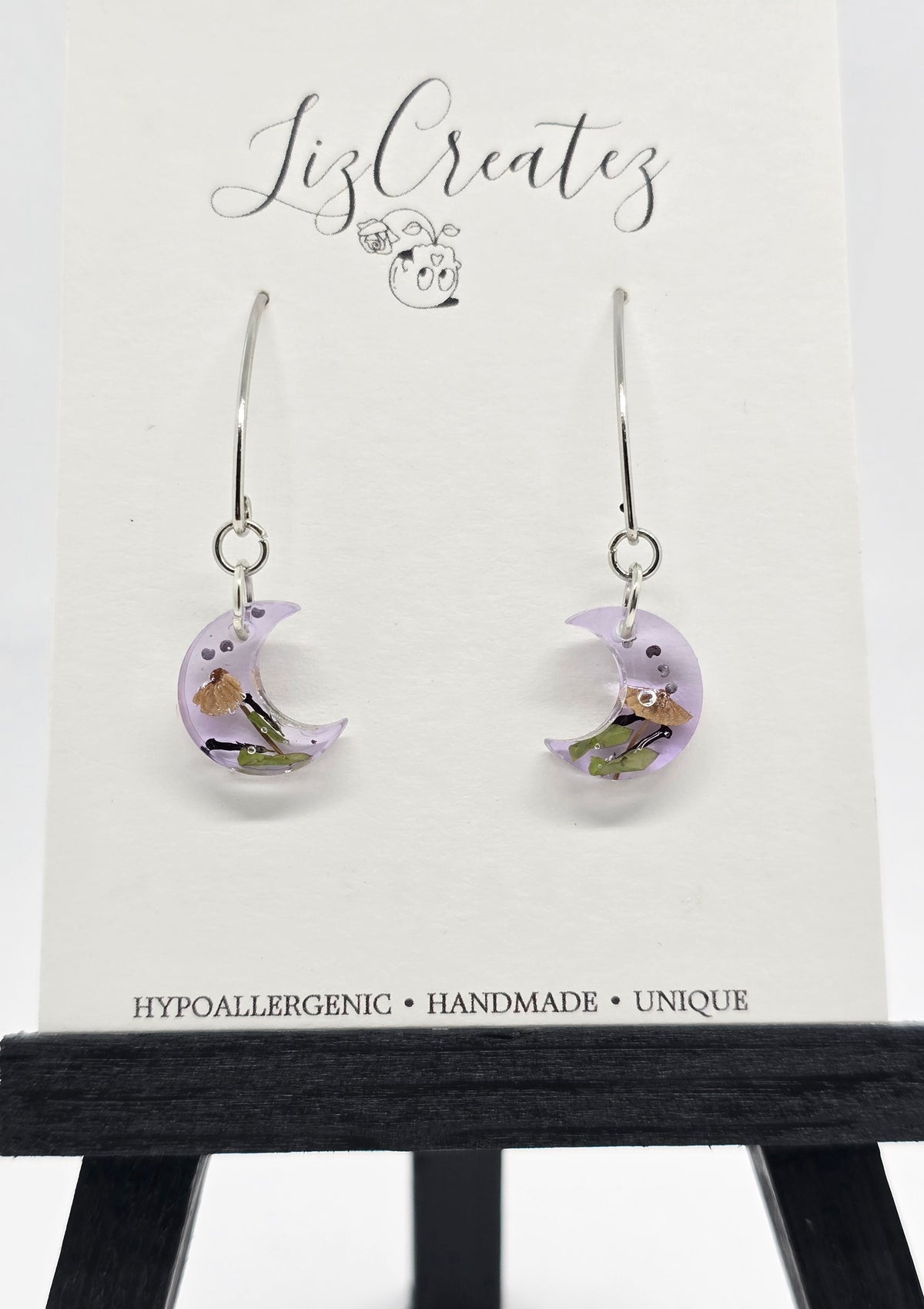 Mini moon-shaped V-hook earrings with a miniature mushroom preserved in clear resin